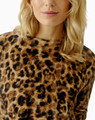 Close-up of leopard knit pattern with fur-yarn texture and ribbed collar