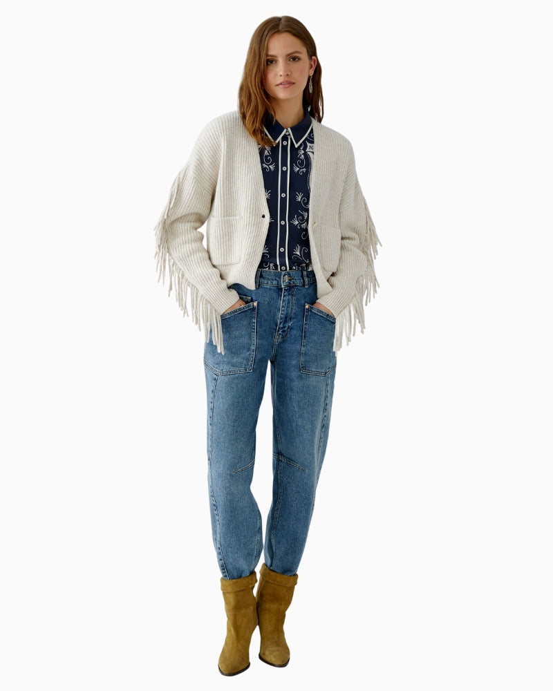 Detail of fringe along sleeve seam and soft cotton-wool fabric
