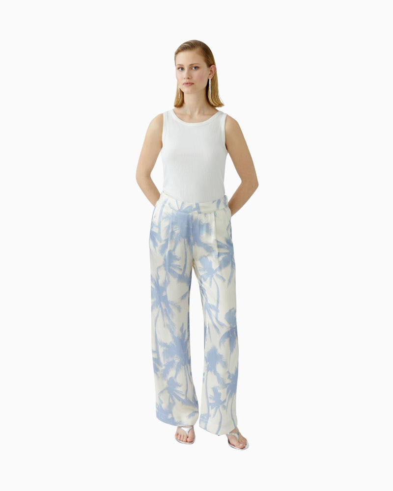 Full body view of model wearing Oui wide-leg trousers with palm print