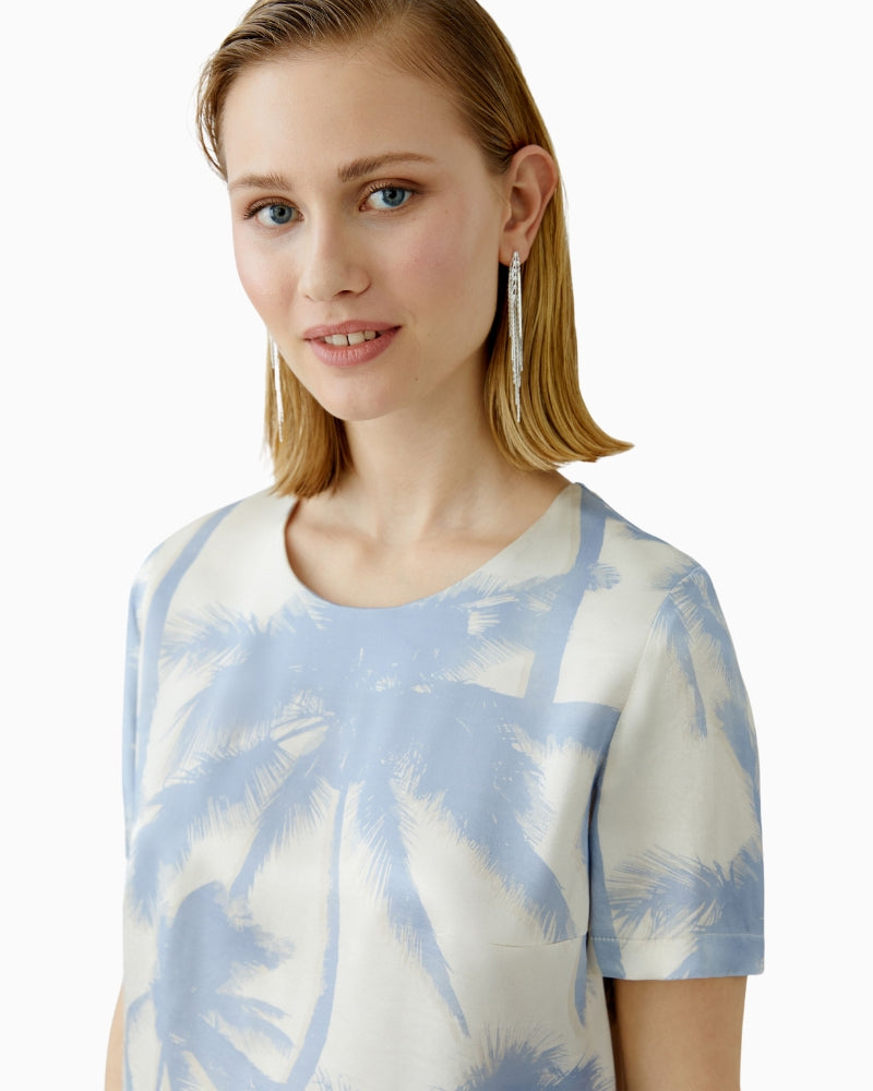 Close up view of Oui blouse paired with matching light trousers