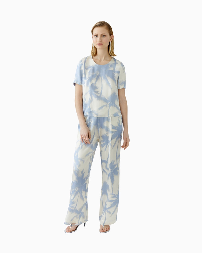 Full body view of Oui blouse paired with matching light trousers