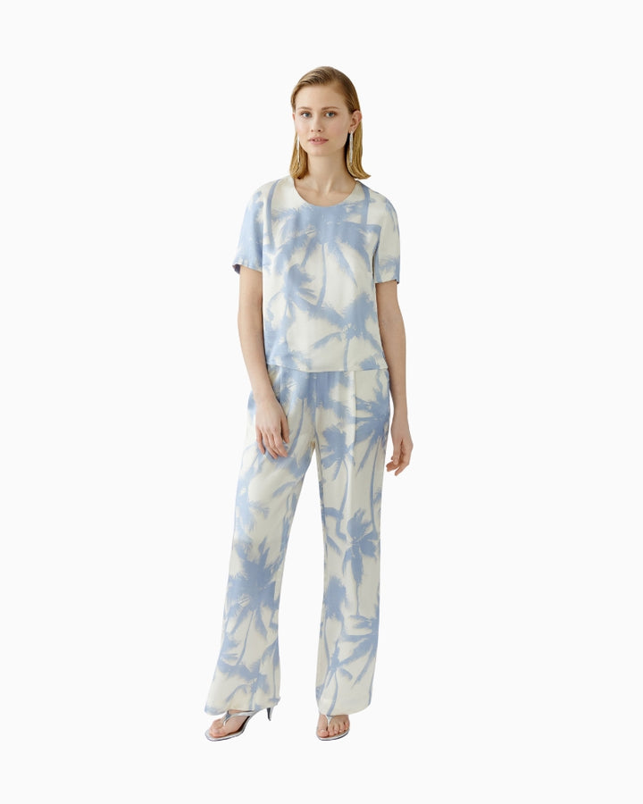 Full body view of Oui blouse paired with matching light trousers