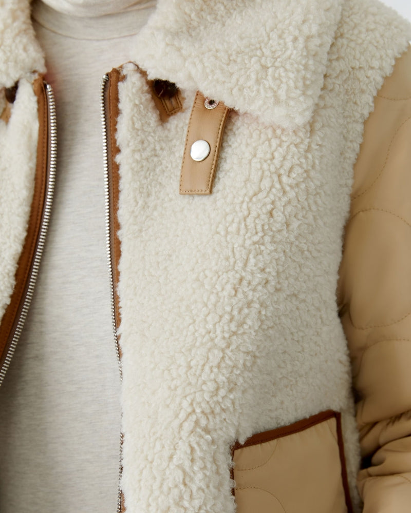Close-up of detachable faux fur collar and strap fastening on Oui jacket
