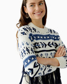 Close-up of knitted jagged pattern and soft fringe detail