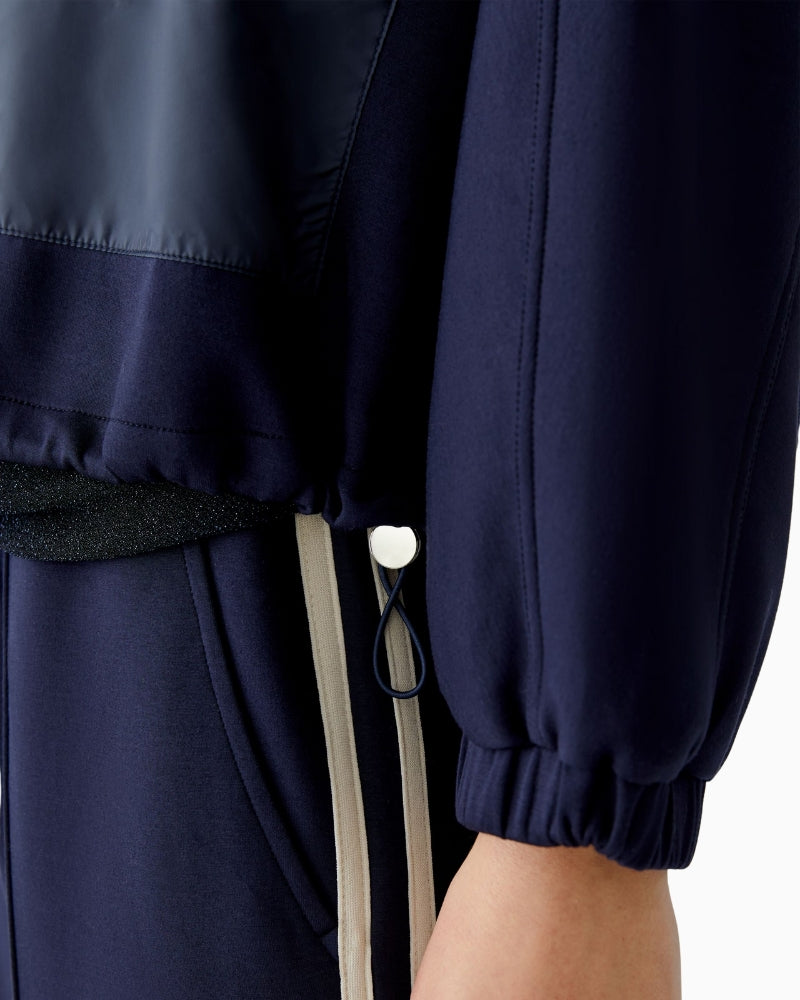 Close up view of Oui jacket in dark blue with drawstring hem detail