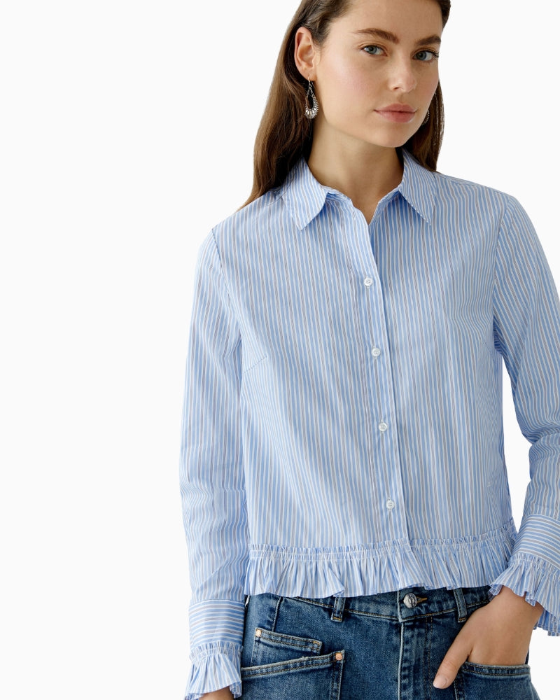 Close-up of long cuffed sleeve and ruffled detail on Oui blouse
