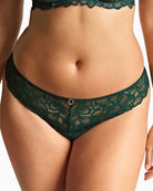Close-up of Panache Allure thong lace fabric in forest green with gold accent