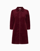 Front view of burgundy corduroy dress by Part Two with zip closure and classic collar