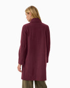 Back view of mid-length port coat with smooth drape