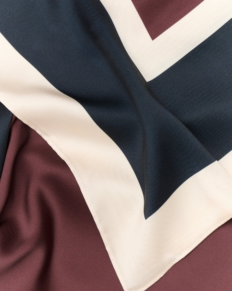 Close up of Part Two satin-effect scarf in Tawny Port and Dark Navy, soft viscose fabric
