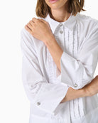 Close-up showing pleated button placket and mixed stripe direction