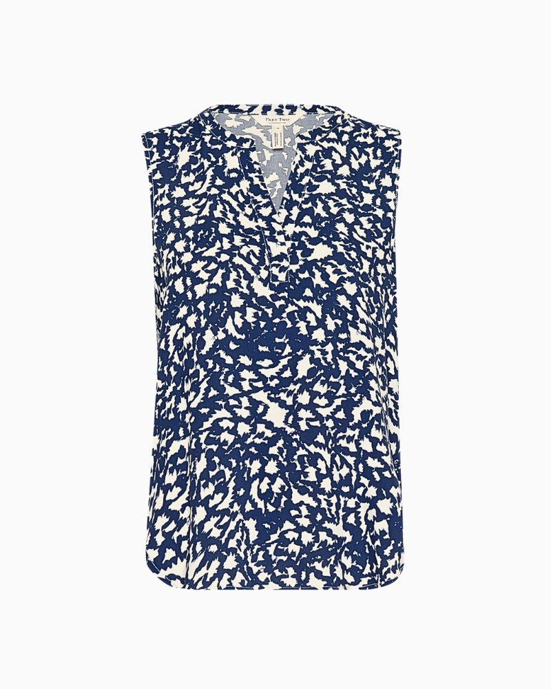 Flat lay of navy sleeveless floral blouse showing button placket and curved hem