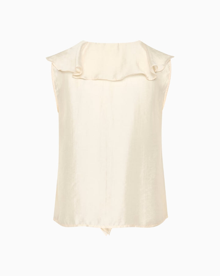 Back side of ivory sleeveless blouse laid flat highlighting minimal seams and soft fabric