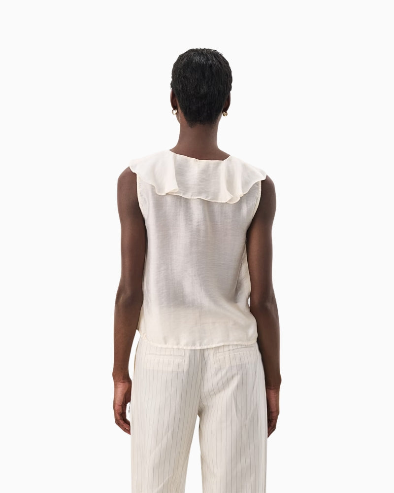 Back view of ivory sleeveless blouse showing clean silhouette and soft drape