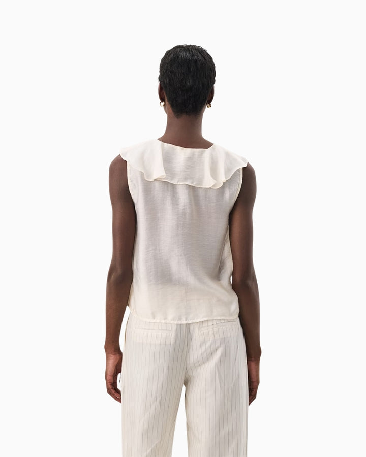 Back view of ivory sleeveless blouse showing clean silhouette and soft drape