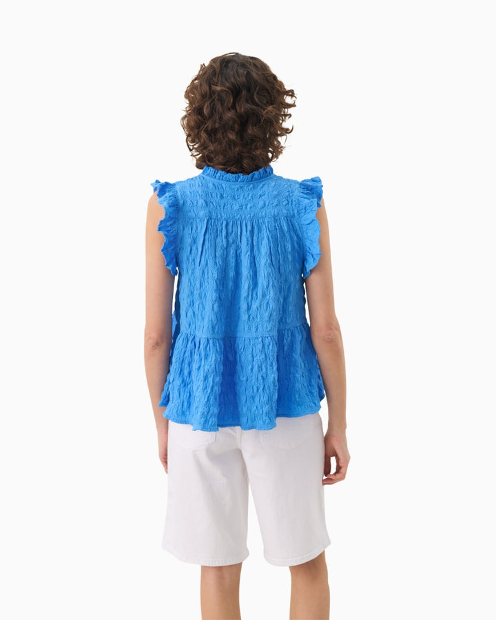 Back view of Part Two blue blouse with tiered gathered detail