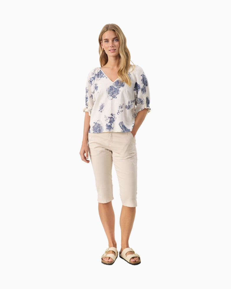 Full length view of model wearing floral oceana blue Part Two blouse with white jeans