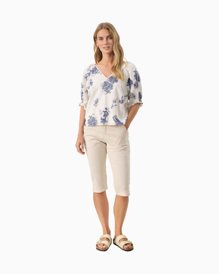 Full length view of model wearing floral oceana blue Part Two blouse with white jeans