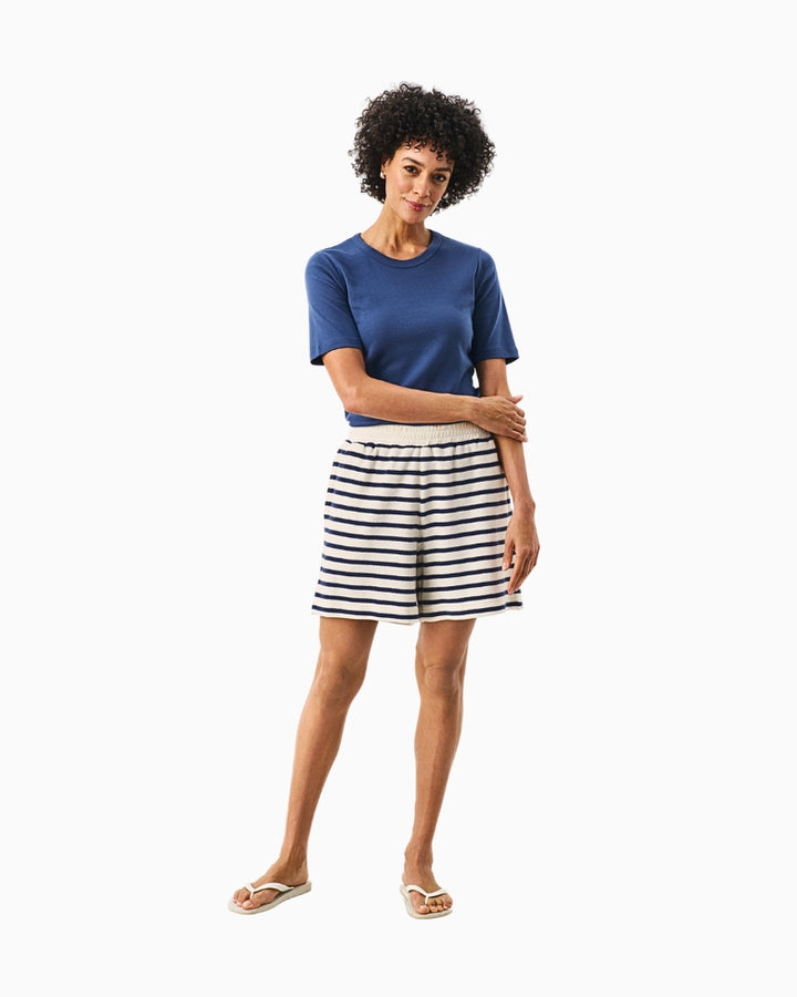 Full length view of model wearing blue and cream Part Two loose fit shorts with T-shirt