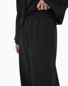 Part Two black trousers with elastic waistband and wide leg fit