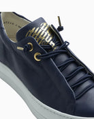 Close-up of smooth navy leather upper and EVA sole