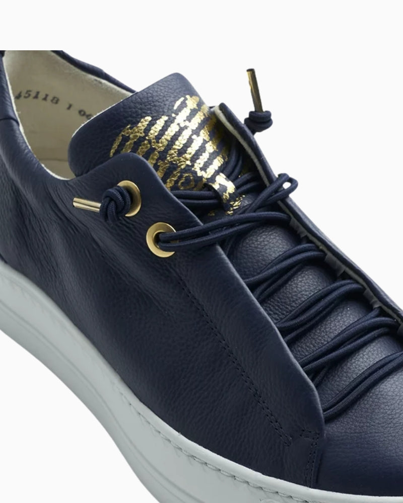 Close-up of smooth navy leather upper and EVA sole