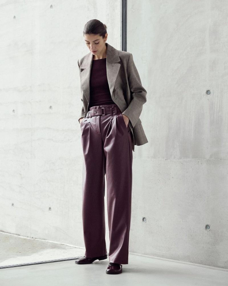 Elegant high-rise trousers styled with blouse for smart casual look