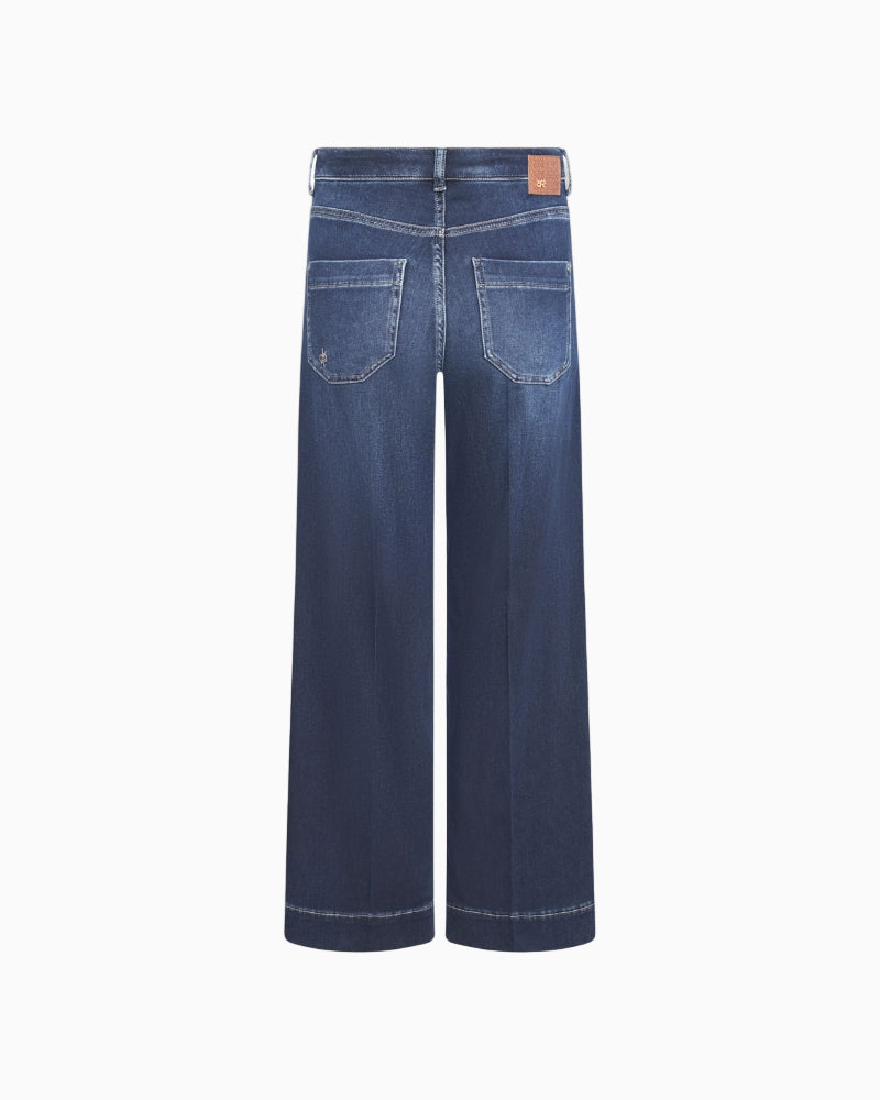 Back view illustrating patch pockets and relaxed fit in soft denim