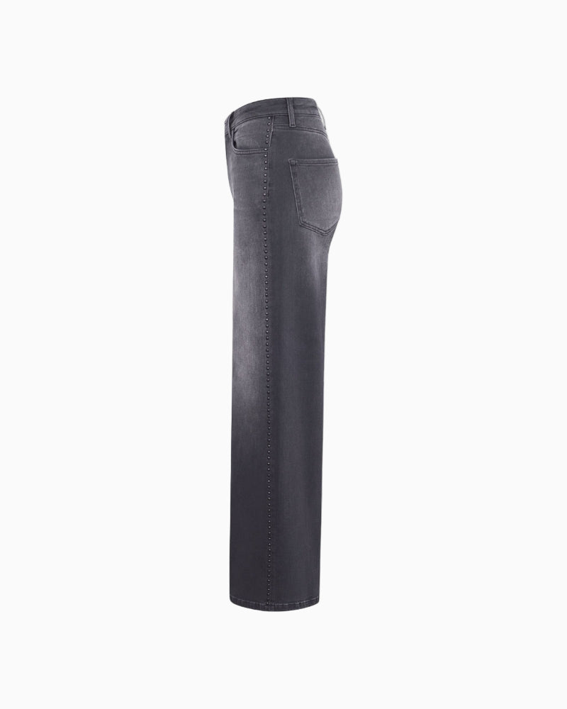 Side view showing wide-leg silhouette and mid-rise fit of grey jeans