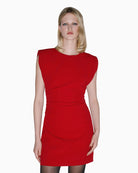 Woman wearing SPELL red mini dress with ruching, front view – Áines Boutique