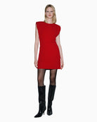Woman wearing SPELL red mini dress, side view showing padded shoulders – Áines Boutique