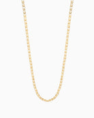 Close-up of gold belcher chain featuring single freshwater pearl detail