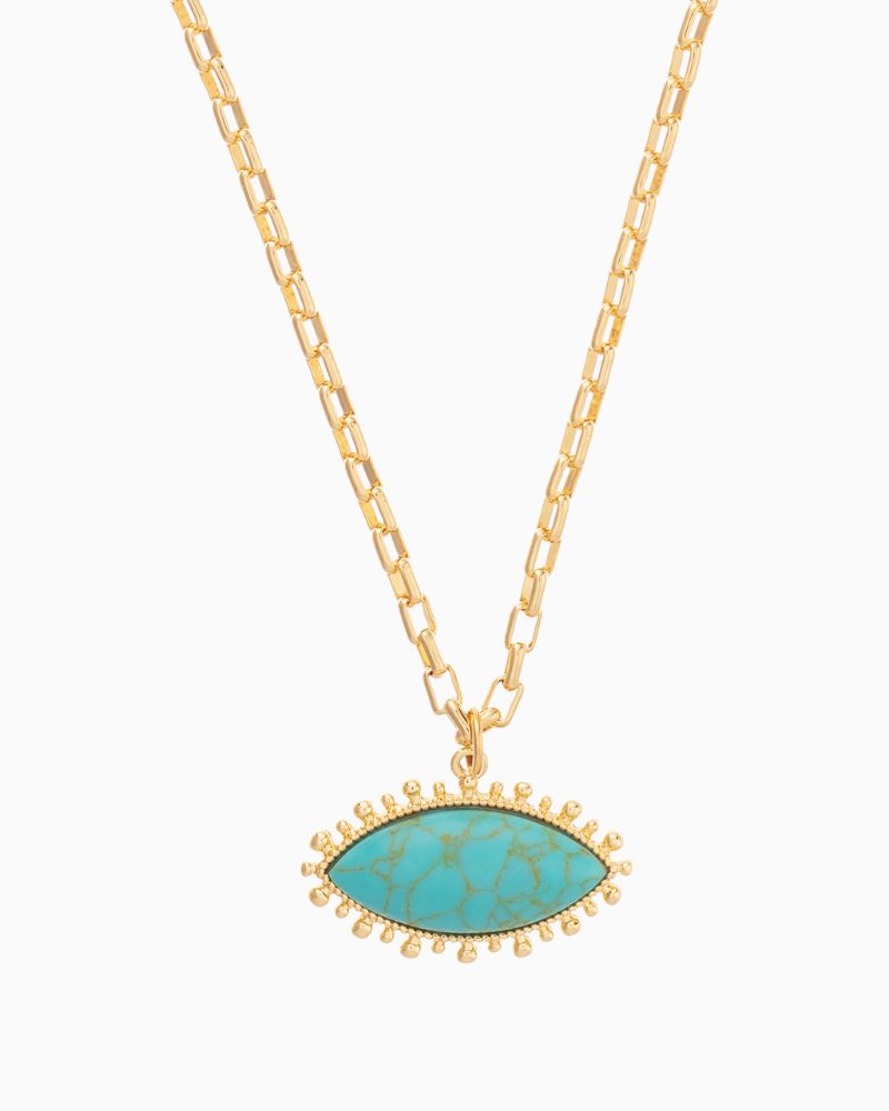 Close-up of evil eye-inspired turquoise pendant on gold plated chain