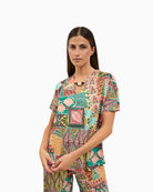 Woman wearing Tinta Arima t-shirt in brown, front view – Áines Boutique