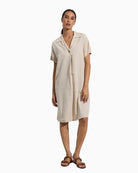 Woman wearing Tinta Morgan dress in khaki, front view – Áines Boutique