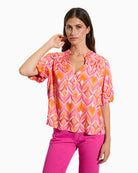 Tinta Salome orange short sleeve blouse, front view on model – Áines Boutique