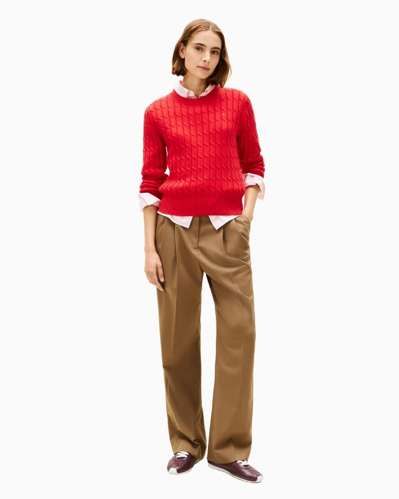 Model wearing red cable jumper styled with jeans