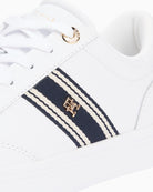 White Tommy Hilfiger trainer close-up of webbing and logo detail – Áines Boutique