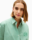 Close-up of collar and branded button placket