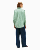Back view of shirt with curved hem and cuff detail