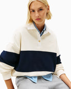 Close-up of gold buttons on structured collar