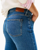 Close up view of bootcut jeans showing flag embroidery on pocket
