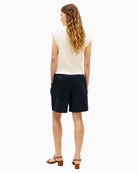 Knee-length navy chino shorts styled casually – Áines Boutique