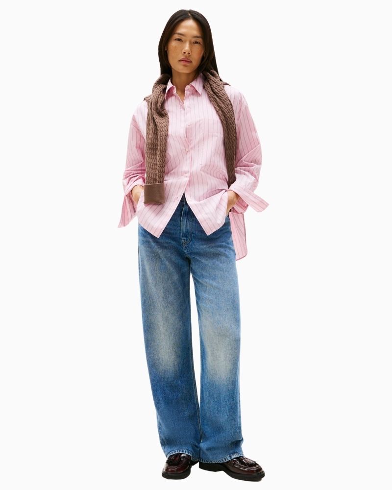 Oversized shirt styled tucked into trousers with rolled cuffs