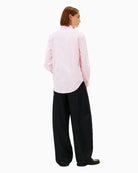 Back view of pink shirt with curved hem and yoke