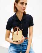 Woman wearing Tommy Hilfiger Popette micro tote raffia – Áines Boutique