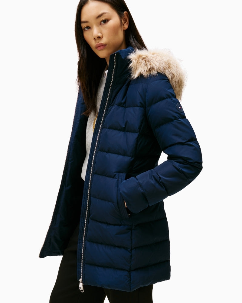 Close-up of detachable faux fur trim on hood of navy down coat