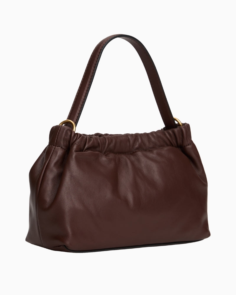 Back view of brown leather mini bag with adjustable strap