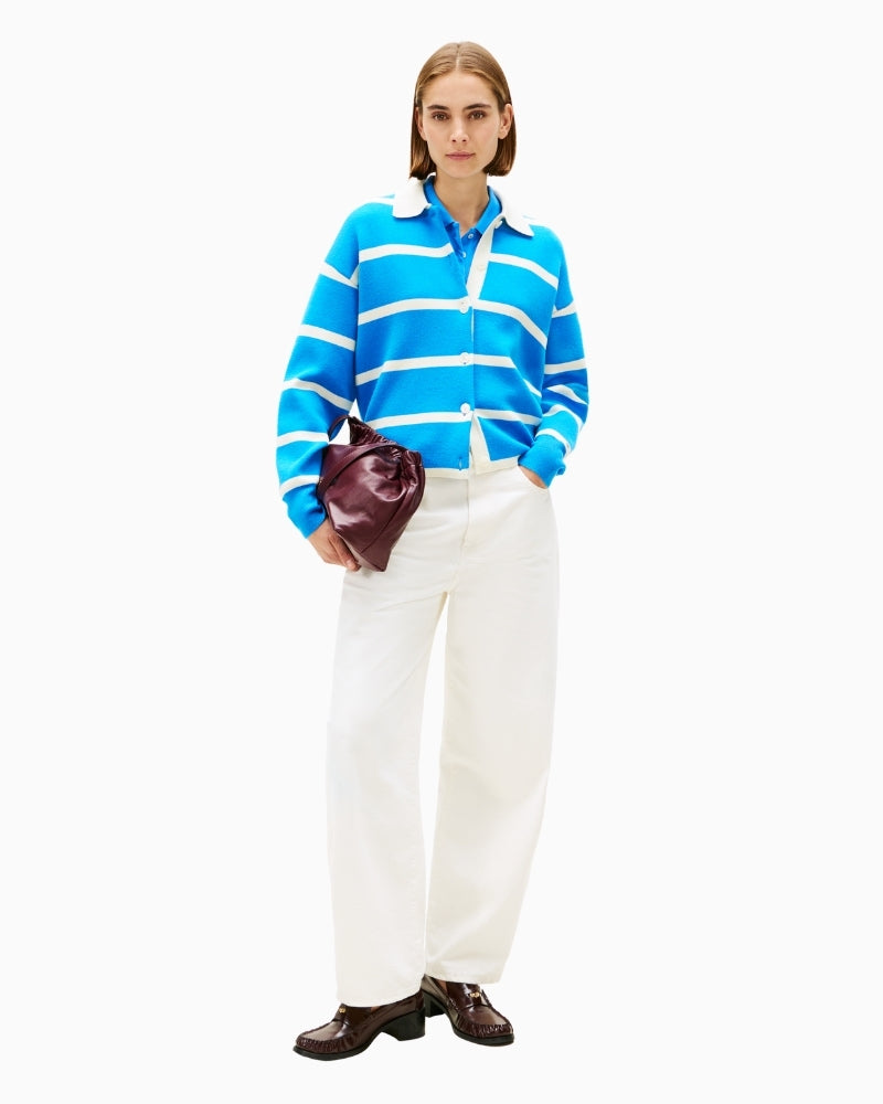 Model styling stripe knit with casual jeans and white trainers