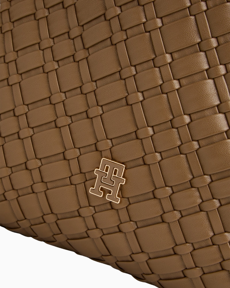 Close-up of braided shoulder strap on Tommy faux leather bag